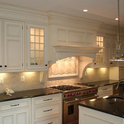 Kitchen - traditional kitchen idea in DC Metro with beaded inset cabinets, stainless steel appliances and white cabinets