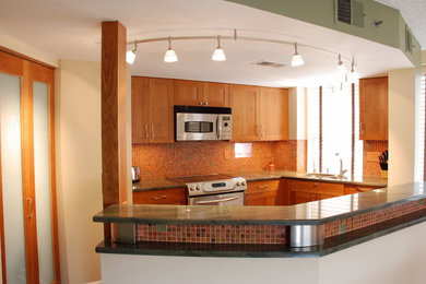 Eat-in kitchen - mid-sized traditional u-shaped ceramic tile eat-in kitchen idea in DC Metro with an undermount sink, shaker cabinets, medium tone wood cabinets, soapstone countertops, brown backsplash, mosaic tile backsplash, stainless steel appliances and an island