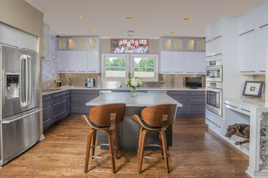 Large trendy u-shaped dark wood floor and brown floor kitchen photo in Other with an undermount sink, flat-panel cabinets, gray cabinets, metallic backsplash, subway tile backsplash, stainless steel appliances and an island
