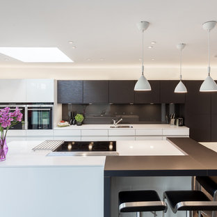 Contemporary kitchen in Glasgow with a single-bowl sink, flat-panel cabinets, brown cabinets, brown splashback, glass sheet splashback, an island and white worktops.