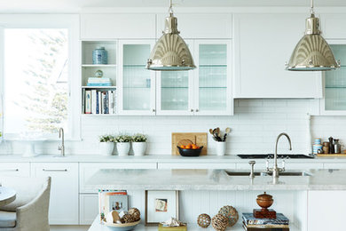 Large nautical single-wall open plan kitchen in Sydney with shaker cabinets, white cabinets, engineered stone countertops, white splashback, ceramic splashback, an island and grey worktops.