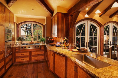 Mid-sized elegant galley medium tone wood floor eat-in kitchen photo in Seattle with an undermount sink, shaker cabinets, medium tone wood cabinets, granite countertops, beige backsplash, stainless steel appliances and an island