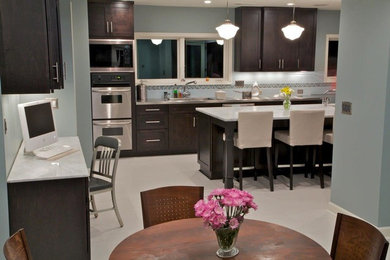 Example of a mid-sized trendy u-shaped porcelain tile eat-in kitchen design in Atlanta with a double-bowl sink, shaker cabinets, stainless steel countertops, blue backsplash, subway tile backsplash, stainless steel appliances and an island