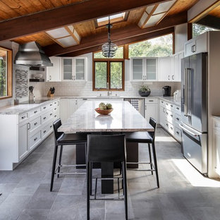 Mid-sized midcentury u-shaped eat-in kitchen in Boston with an undermount sink, white cabinets, quartz benchtops, subway tile splashback, stainless steel appliances, porcelain floors, with island, grey floor, recessed-panel cabinets, white splashback and grey benchtop.