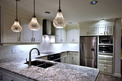 Mid-sized transitional u-shaped porcelain tile and brown floor eat-in kitchen photo in Toronto with an undermount sink, raised-panel cabinets, quartzite countertops, white backsplash, stainless steel appliances, white cabinets and a peninsula