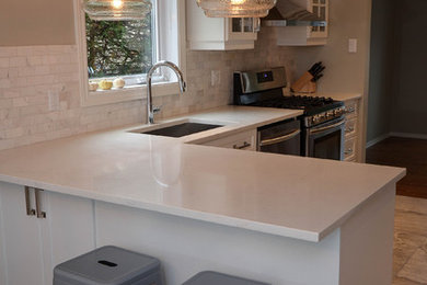 Trendy kitchen photo in Ottawa with an undermount sink, shaker cabinets, white cabinets, quartzite countertops and a peninsula