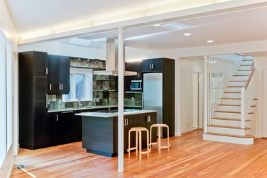 Large trendy l-shaped medium tone wood floor kitchen photo in Boston with green backsplash, stainless steel appliances and an island