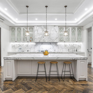 Inspiration for a large transitional eat-in kitchen in Melbourne with an undermount sink, glass-front cabinets, white cabinets, marble benchtops, marble splashback, black appliances, dark hardwood floors and with island.