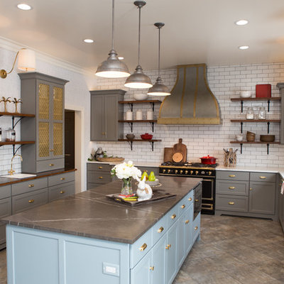 Enclosed kitchen - large transitional porcelain tile and gray floor enclosed kitchen idea in Chicago with a farmhouse sink, shaker cabinets, gray cabinets, limestone countertops, white backsplash, subway tile backsplash, black appliances, an island and gray countertops
