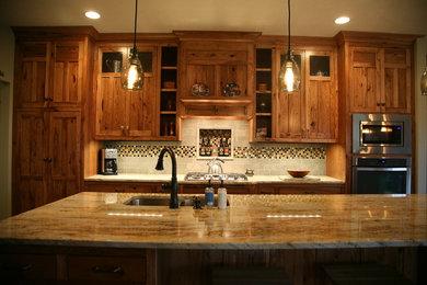 Example of a classic kitchen design in Other with light wood cabinets and an island