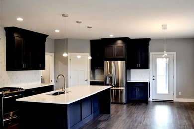 Example of a minimalist l-shaped open concept kitchen design in Other with shaker cabinets, blue cabinets, quartz countertops and white countertops
