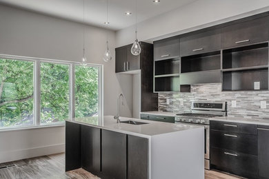Enclosed kitchen - mid-sized contemporary galley dark wood floor enclosed kitchen idea in Atlanta with an undermount sink, flat-panel cabinets, black cabinets, solid surface countertops, multicolored backsplash, matchstick tile backsplash, stainless steel appliances and an island
