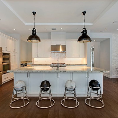 Example of a large transitional l-shaped dark wood floor eat-in kitchen design in Miami with shaker cabinets, white cabinets, white backsplash, stainless steel appliances, an undermount sink, recycled glass countertops, subway tile backsplash and an island