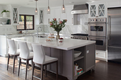 Example of a tuscan l-shaped eat-in kitchen design in San Diego with an undermount sink, shaker cabinets, gray cabinets, marble countertops, white backsplash, stone slab backsplash and stainless steel appliances