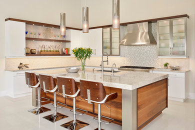 Inspiration for a contemporary l-shaped beige floor kitchen remodel in Miami with an undermount sink, flat-panel cabinets, white cabinets, multicolored backsplash, mosaic tile backsplash, stainless steel appliances, an island and beige countertops