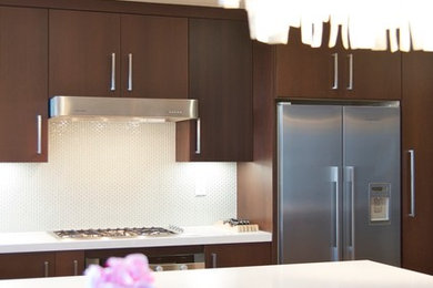 Example of a mid-sized minimalist single-wall light wood floor and brown floor eat-in kitchen design in Los Angeles with an undermount sink, flat-panel cabinets, dark wood cabinets, quartz countertops, blue backsplash, mosaic tile backsplash, stainless steel appliances and a peninsula