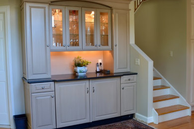 Example of a large classic kitchen design in Boston with raised-panel cabinets, quartz countertops and two islands