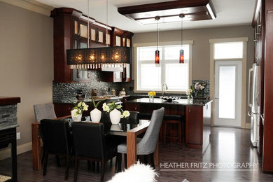 Inspiration for a mid-sized contemporary l-shaped medium tone wood floor open concept kitchen remodel in Other with shaker cabinets, dark wood cabinets, granite countertops, gray backsplash, glass sheet backsplash, stainless steel appliances, an island and an undermount sink