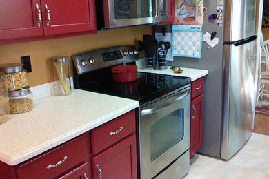 Inspiration for a small modern galley ceramic tile eat-in kitchen remodel in Louisville with an integrated sink, recessed-panel cabinets, red cabinets, solid surface countertops, stainless steel appliances and no island