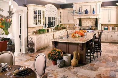 Example of a huge slate floor eat-in kitchen design in New York with beige backsplash, stainless steel appliances, an island, beige cabinets, a double-bowl sink, beaded inset cabinets, granite countertops and stone tile backsplash