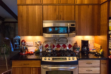 Zweizeilige, Mittelgroße Moderne Wohnküche mit flächenbündigen Schrankfronten, hellbraunen Holzschränken, Granit-Arbeitsplatte, Küchenrückwand in Weiß, Rückwand aus Keramikfliesen, Küchengeräten aus Edelstahl und Keramikboden in Denver