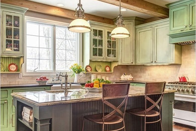 Large transitional l-shaped medium tone wood floor eat-in kitchen photo in St Louis with a farmhouse sink, recessed-panel cabinets, green cabinets, granite countertops, beige backsplash, subway tile backsplash, stainless steel appliances and an island