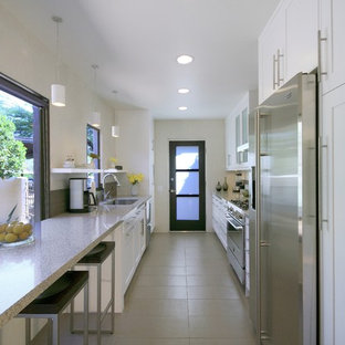 Enclosed kitchen - contemporary galley enclosed kitchen idea in Phoenix with stainless steel appliances and quartz countertops