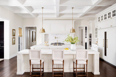 Inspiration for a mediterranean u-shaped medium tone wood floor, brown floor and coffered ceiling eat-in kitchen remodel in Phoenix with a farmhouse sink, recessed-panel cabinets, white cabinets, multicolored backsplash, paneled appliances, two islands and multicolored countertops