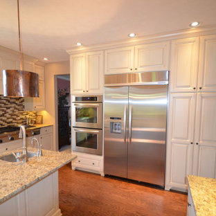 Mid-sized transitional eat-in kitchen pictures - Inspiration for a mid-sized transitional u-shaped medium tone wood floor and brown floor eat-in kitchen remodel in Other with an undermount sink, raised-panel cabinets, beige cabinets, granite countertops, multicolored backsplash, mosaic tile backsplash, stainless steel appliances, an island and multicolored countertops