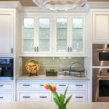 Designer white kitchen  inset custom cabinets and glass doors with glass shelves