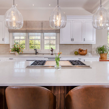 Designer white kitchen with select walnut island