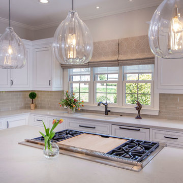 Designer white kitchen with walnut island