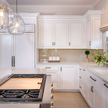 Designer white kitchen with walnut island