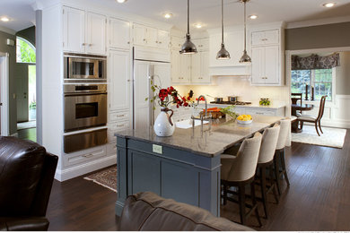Example of a large minimalist l-shaped dark wood floor eat-in kitchen design in Baltimore with a farmhouse sink, granite countertops, white backsplash, ceramic backsplash, stainless steel appliances and an island