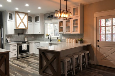 Mid-sized trendy u-shaped eat-in kitchen photo in Other with a farmhouse sink, shaker cabinets, white cabinets and a peninsula