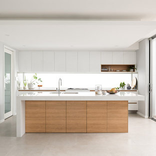 This is an example of a contemporary l-shaped kitchen in Perth with an undermount sink, flat-panel cabinets, white cabinets, white splashback, window splashback, with island, grey floor and white benchtop.