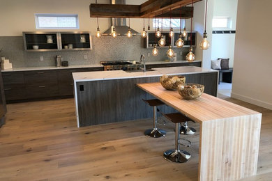 Open concept kitchen - large modern l-shaped open concept kitchen idea in Denver with glass-front cabinets, gray cabinets, quartz countertops, multicolored backsplash, an island and white countertops