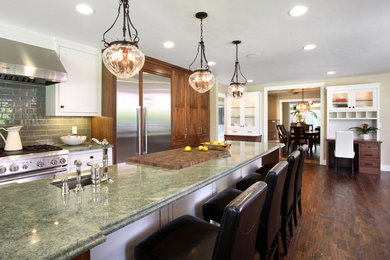 Example of a mid-sized transitional u-shaped medium tone wood floor eat-in kitchen design in San Francisco with medium tone wood cabinets, granite countertops, green backsplash, stainless steel appliances, an island, an undermount sink, shaker cabinets and subway tile backsplash