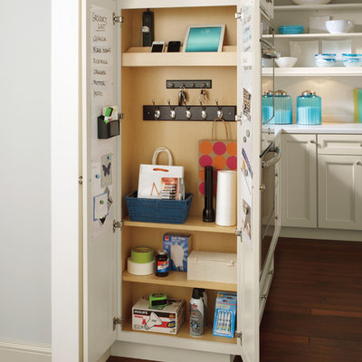 Elegant l-shaped medium tone wood floor kitchen pantry photo in Other with white countertops, recessed-panel cabinets, beige cabinets and white backsplash