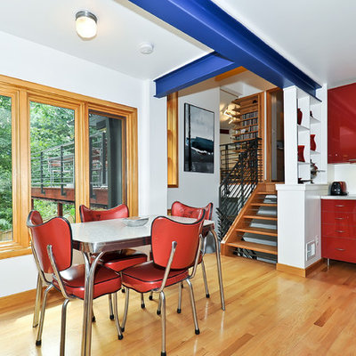 Trendy eat-in kitchen photo in DC Metro with flat-panel cabinets, red cabinets and stainless steel appliances