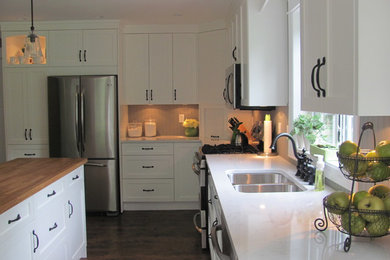 Inspiration for a contemporary l-shaped eat-in kitchen remodel in Vancouver with an undermount sink, shaker cabinets, white cabinets, quartz countertops, gray backsplash and stainless steel appliances