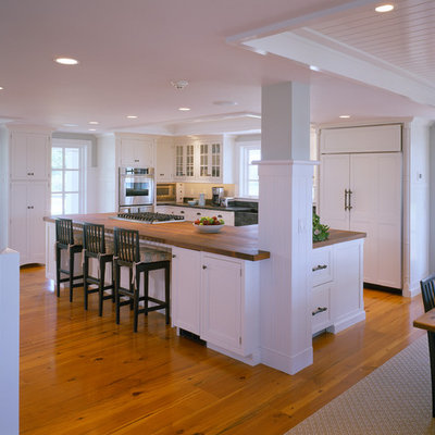 Example of a classic kitchen design in Boston with a farmhouse sink and wood countertops