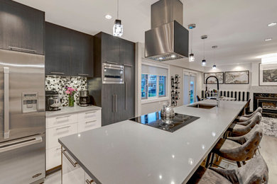 Kitchen - transitional laminate floor kitchen idea in Vancouver with an undermount sink, flat-panel cabinets, dark wood cabinets, quartz countertops, multicolored backsplash, mosaic tile backsplash, stainless steel appliances and gray countertops