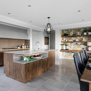 This is an example of a contemporary galley eat-in kitchen in Adelaide with an undermount sink, flat-panel cabinets, medium wood cabinets, brown splashback, with island, grey floor and white benchtop.