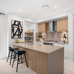 Inspiration for a contemporary galley kitchen in Sydney with a double-bowl sink, flat-panel cabinets, medium wood cabinets, brown splashback, stainless steel appliances, a peninsula, white floor and brown benchtop.