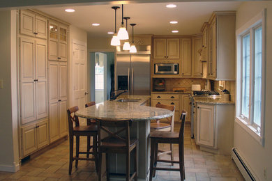 Example of a mid-sized classic l-shaped travertine floor eat-in kitchen design in Detroit with a single-bowl sink, raised-panel cabinets, white cabinets, granite countertops, white backsplash, stone tile backsplash, stainless steel appliances and an island