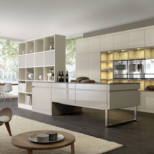 This is an example of a modern galley open plan kitchen in Boston with stainless steel appliances, open cabinets and white cabinets.