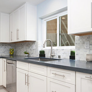 Inspiration for a large traditional l-shaped eat-in kitchen in San Diego with an undermount sink, shaker cabinets, white cabinets, quartz benchtops, multi-coloured splashback, stone tile splashback, stainless steel appliances, porcelain floors, with island, grey floor and blue benchtop.