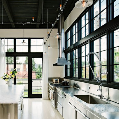 Kitchen - industrial single-wall kitchen idea in Portland with an integrated sink, stainless steel cabinets, stainless steel countertops, metallic backsplash, metal backsplash and stainless steel appliances