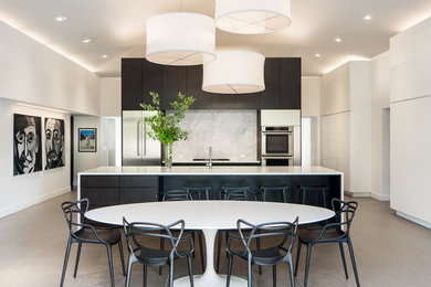 Inspiration for a contemporary porcelain tile eat-in kitchen remodel in Denver with quartzite countertops, stone slab backsplash, stainless steel appliances, an island, an undermount sink, flat-panel cabinets and white backsplash